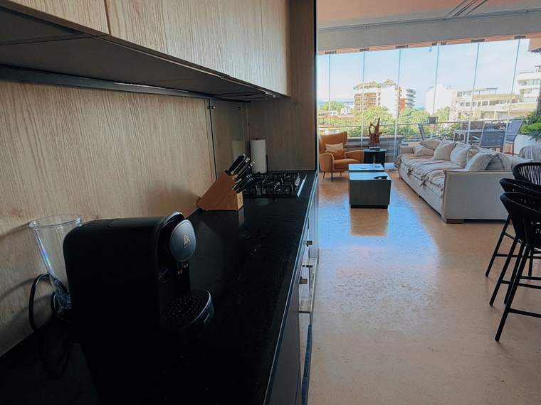 Kitchen opening onto the living room and terrace
